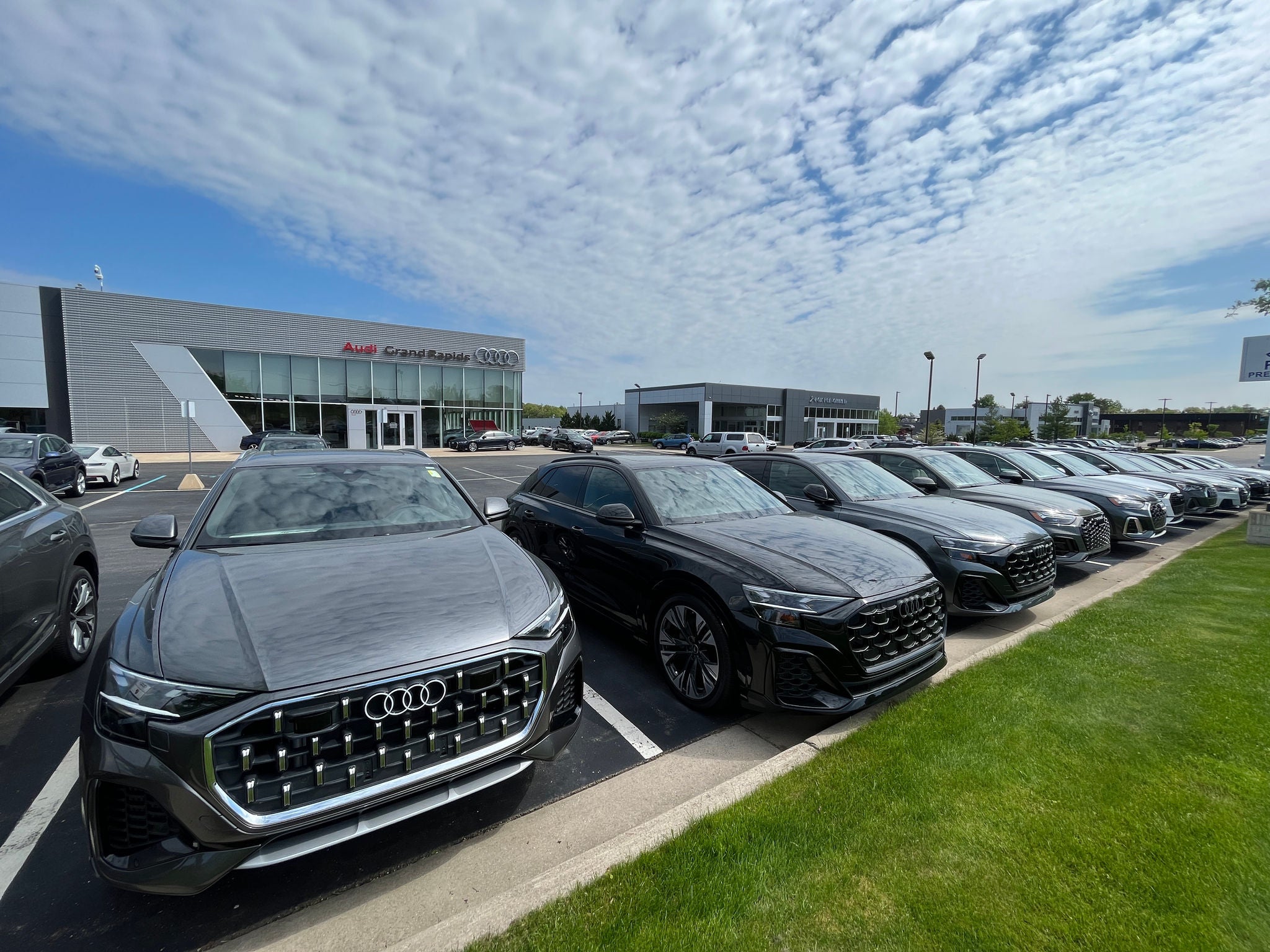 Audi vehicles parked at dealership. 